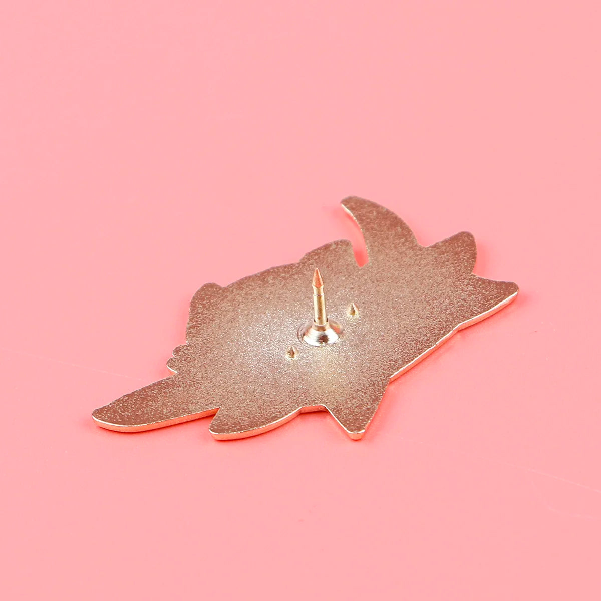 Back side of cat-shaped enamel pin showing metal post and secure stud, ideal for jackets, bags, and display boards