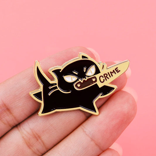 Black cat enamel pin shown in hand for size reference, great for jackets, backpacks, and cute gift ideas