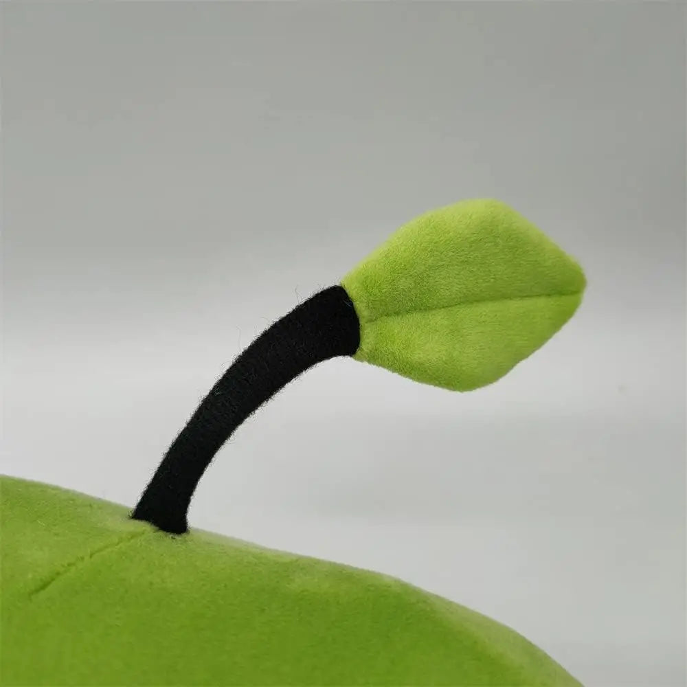 Green Junimo plushie close-up focusing on the leaf and stem details