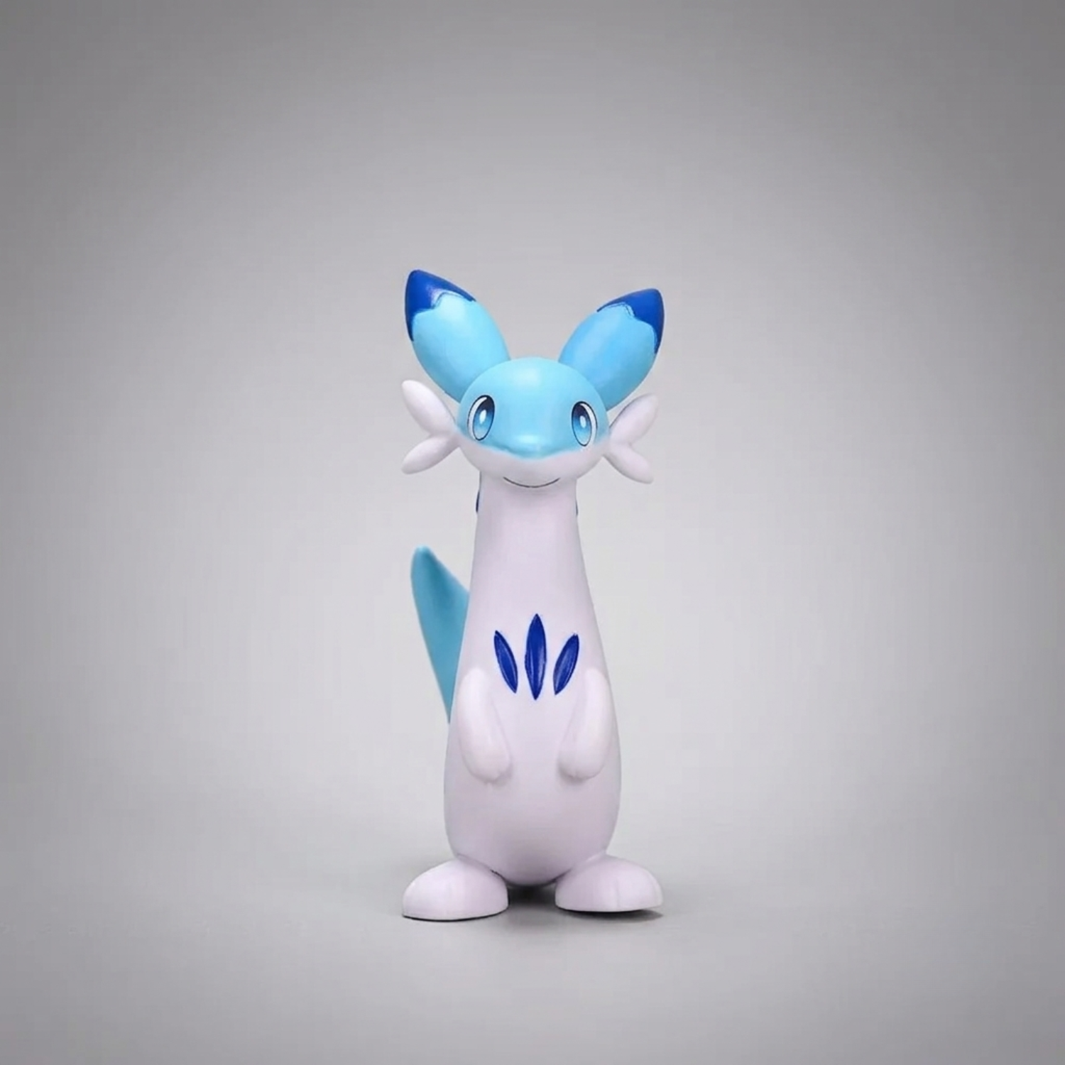 Front-facing blue-and-white Chillet figurine from Palworld, standing upright and smiling against a light gray background.

