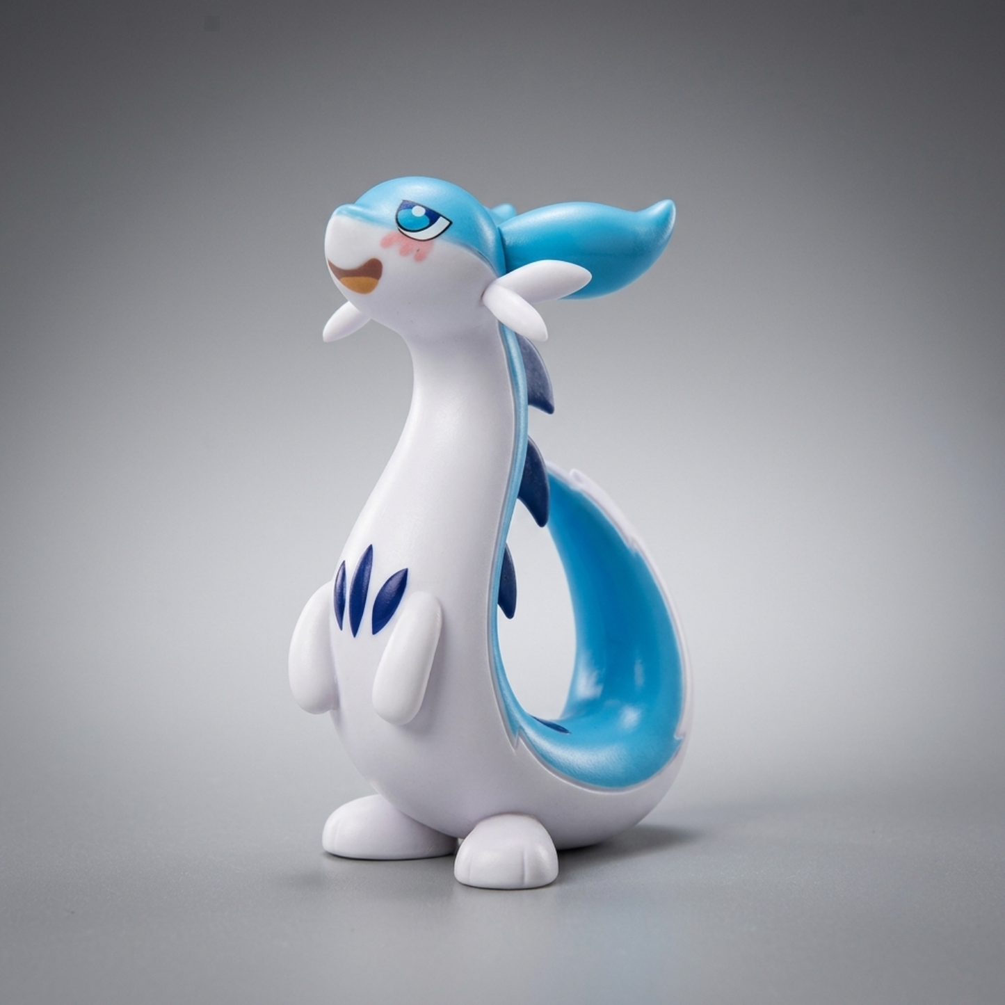 Blue-and-white Chillet figurine from Palworld standing upright with its long tail curled behind it against a gray background.
