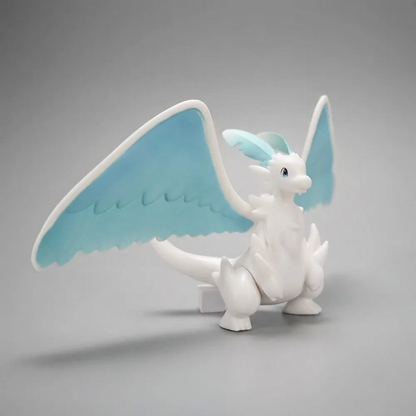 White-and-blue Quivern figurine from Palworld standing with its large wings spread against a soft gray background.
