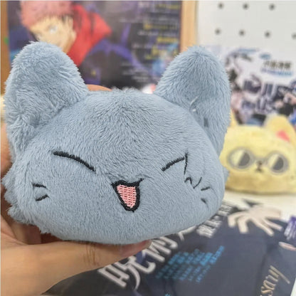 Geto plush toy with cat ears held in front of a blurred background