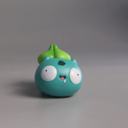 Funny Bulbasaur figurine with a round, derpy face, wide eyes, and a playful smile, showcasing a humorous take on the beloved Pokémon character.