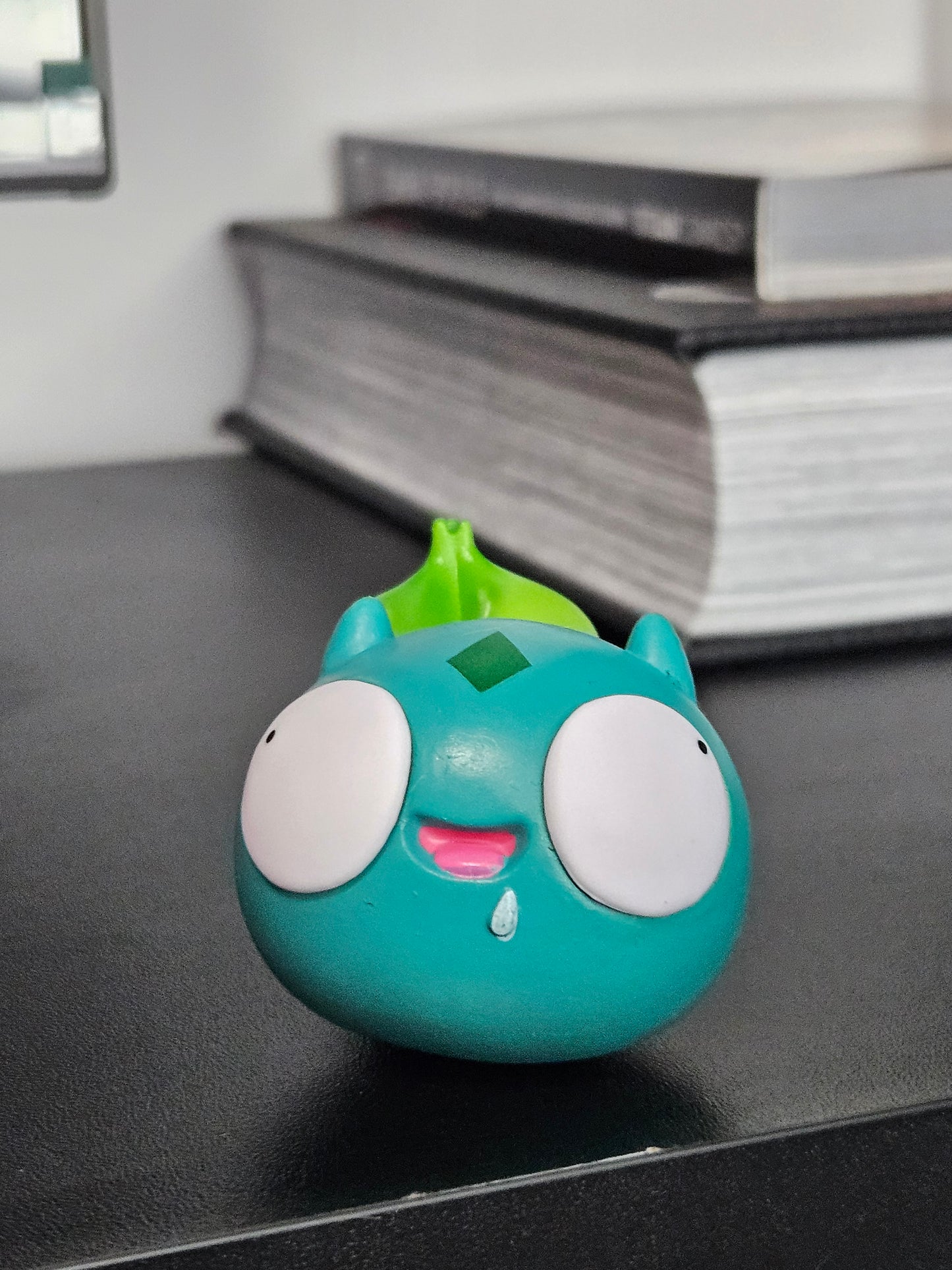 Funny Bulbasaur figurine with wide, derpy eyes, a playful smile, and its signature green bulb, bringing a humorous twist to the classic Pokémon design