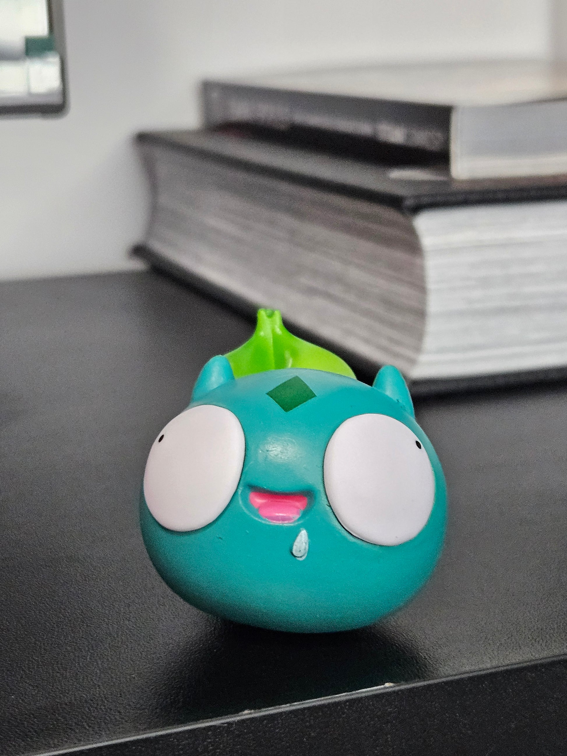Funny Bulbasaur figurine with wide, derpy eyes, a playful smile, and its signature green bulb, bringing a humorous twist to the classic Pokémon design