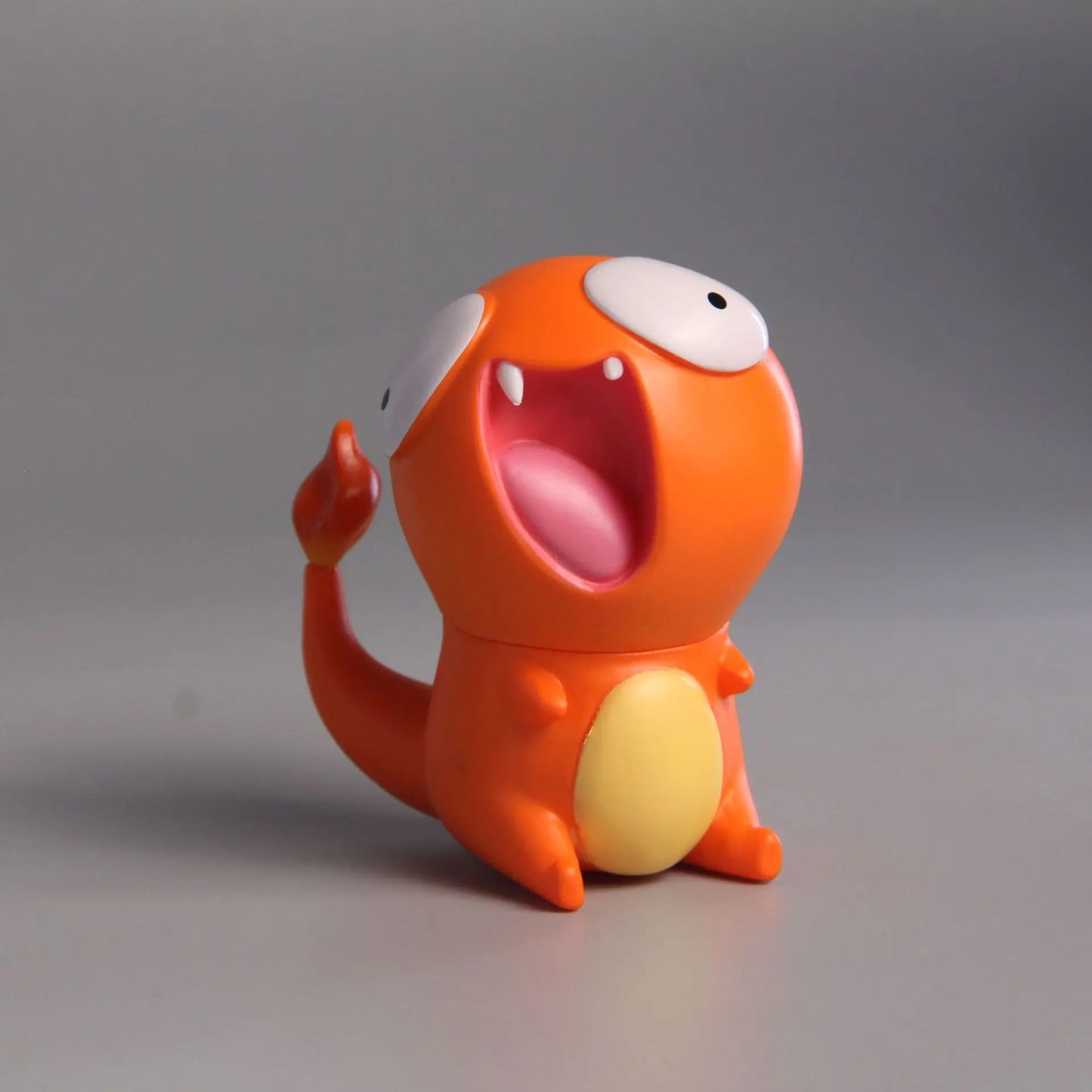 Funny Charmander figurine with a derpy expression, featuring exaggerated wide eyes and an open mouth for a humorous, playful design.