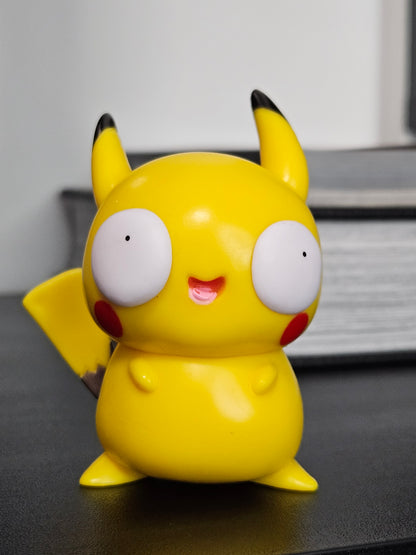 Funny Pikachu figurine with wide, derpy eyes, red cheeks, and a playful smile, featuring its iconic yellow design, perfect for adding a humorous touch to any Pokémon fan's collection