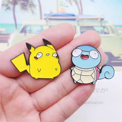 PokeDerp Pikachu and Squirtle pins held in hand.