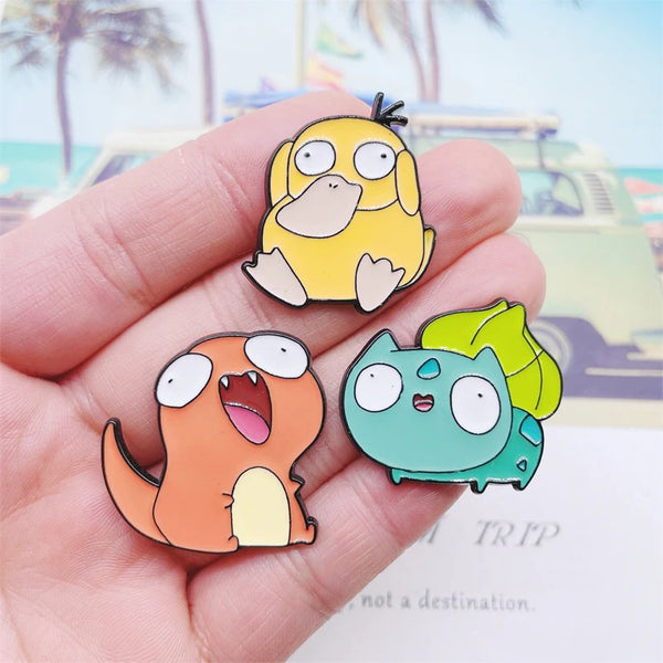 Group of PokeDerp Pokémon pins featuring Charmander, Pikachu, Squirtle, Bulbasaur, and Psyduck held in hand.