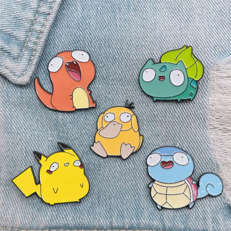PokeDerp Pokémon pins displayed on denim fabric, showing their versatility for clothing or accessories.